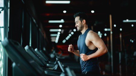 Men exercising on treadmills in a modern gym